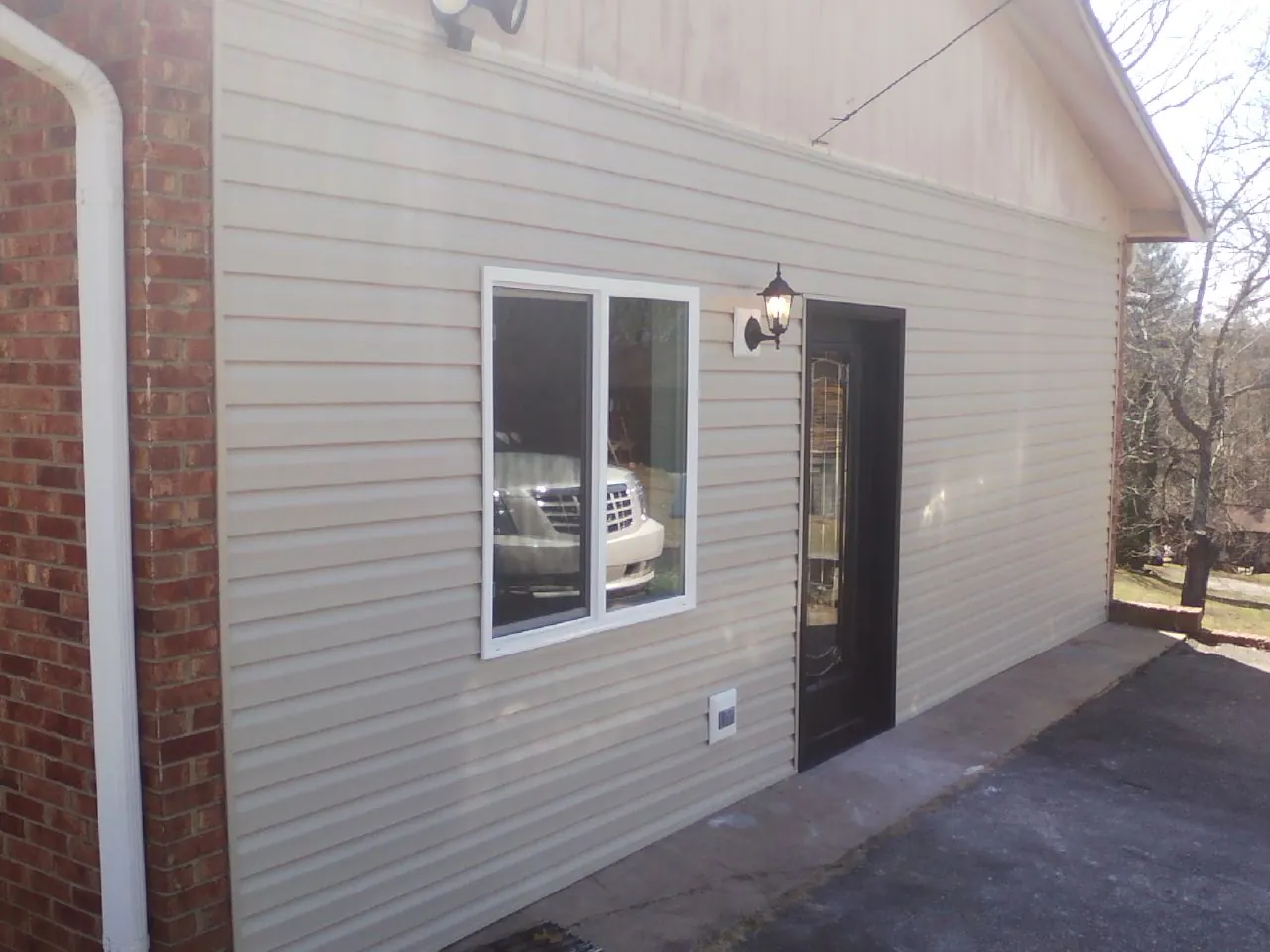 New vinyl siding and entry door on a room addition in Elbridge