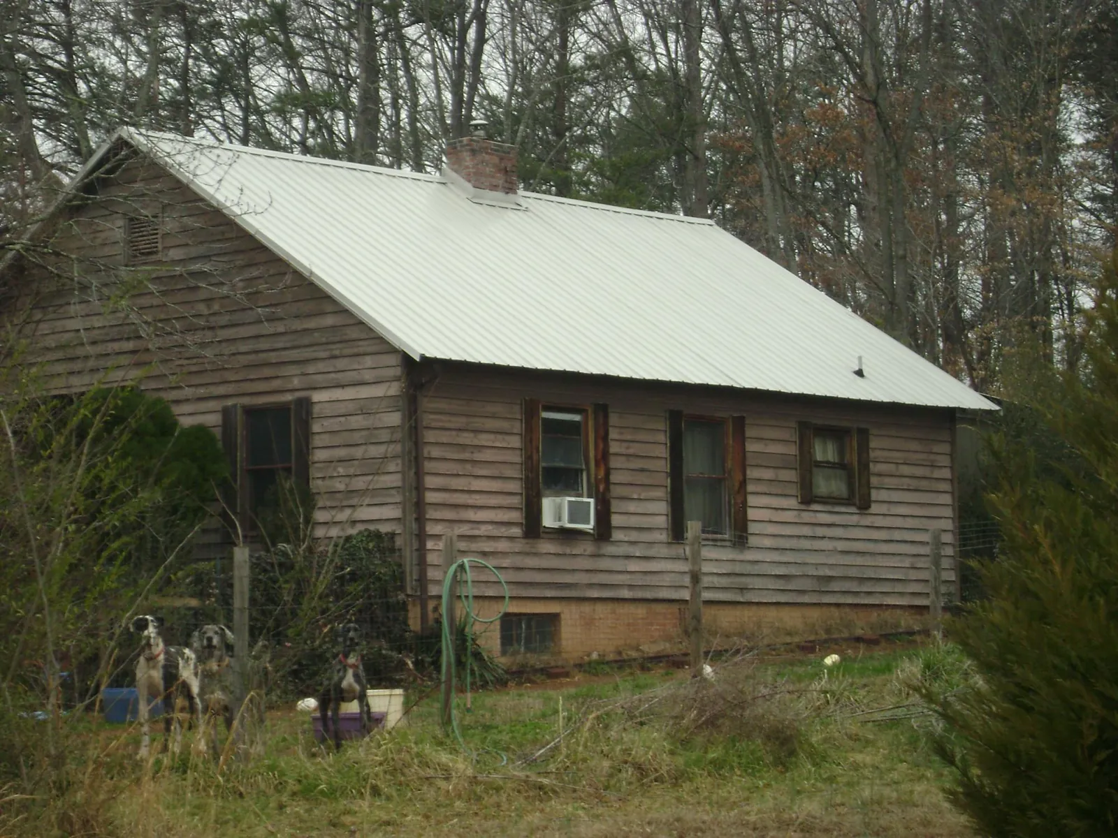 White metal roof on an old wood sided farmhouse, from a Metal Roof Installation job in Elbridge